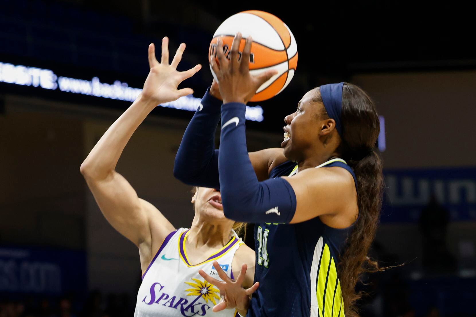 Dallas Wings guard Arike Ogunbowale, right, drives to the basket past Los Angeles Sparks...
