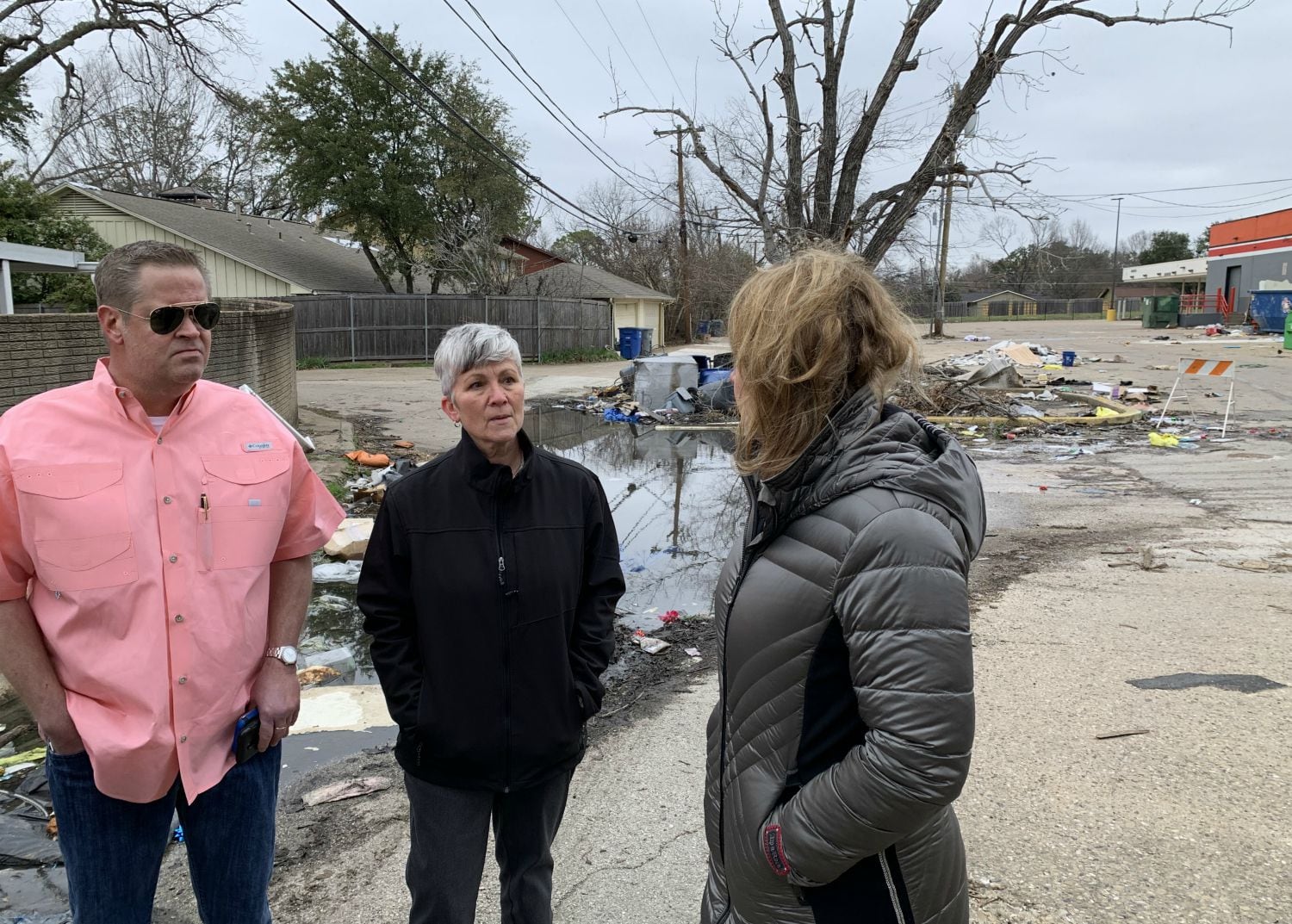 Christian Guillot, left, and his neighbor Dawn Lee discuss the impact of the October tornado...