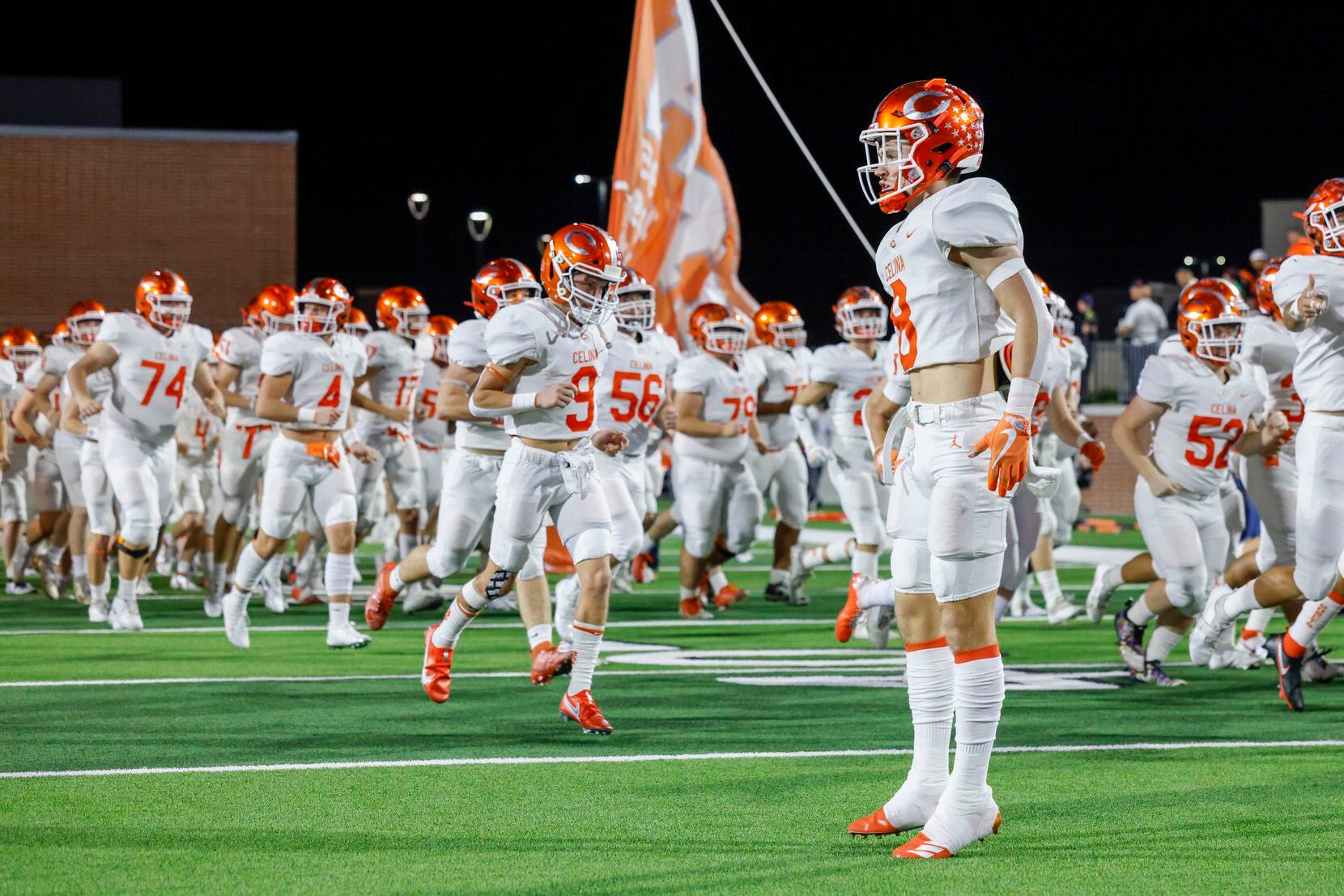 Celina quarterback Collin McKiddy (8) jumps as the team takes the field before their Class...