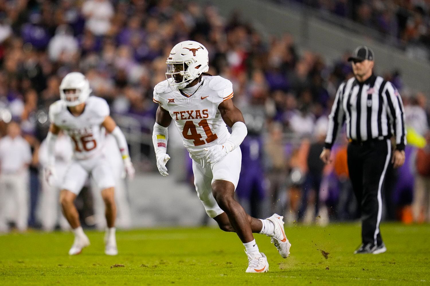 Texas linebacker Jaylan Ford rushes in during the first half of an NCAA college football...