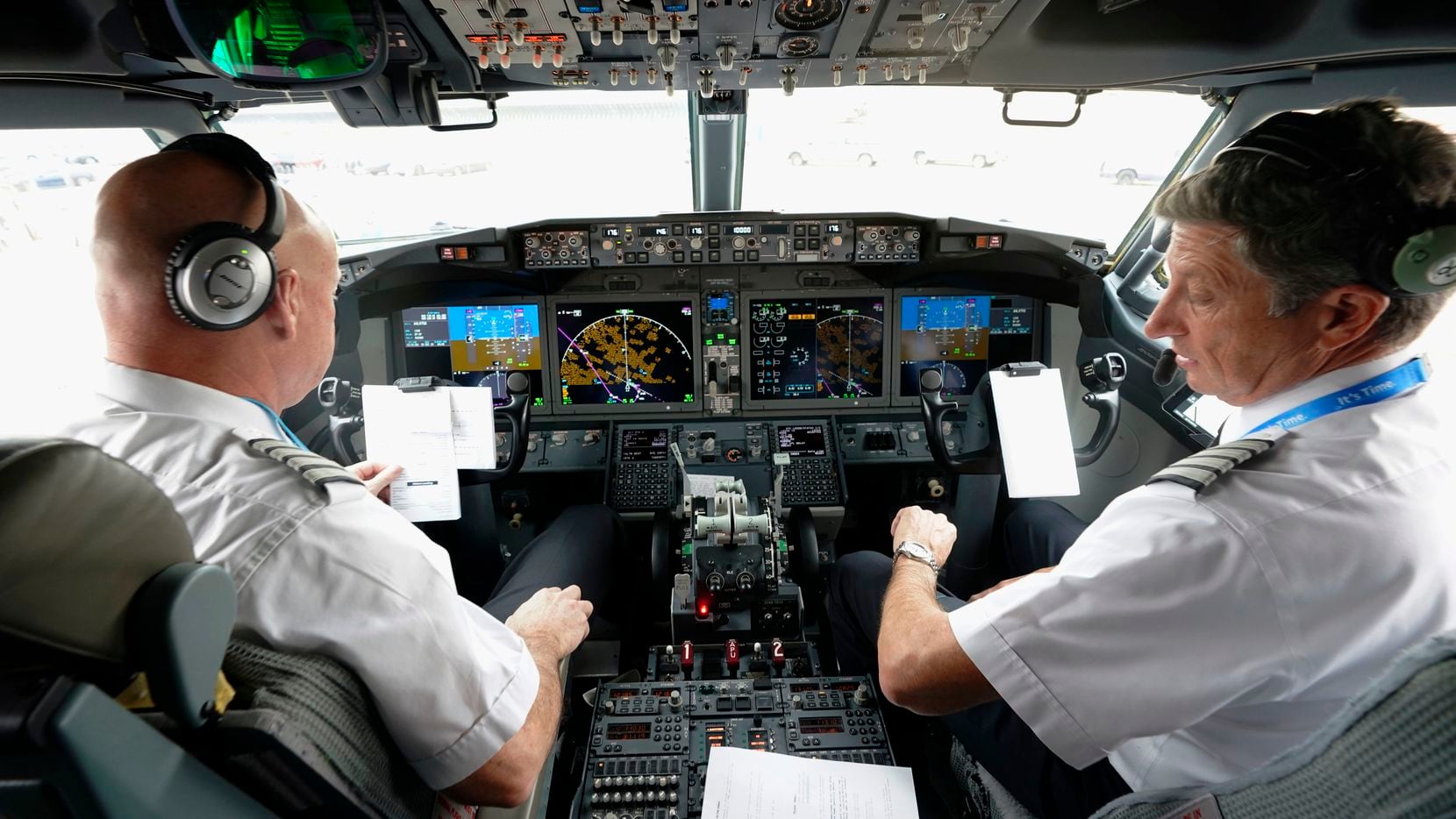 American Airlines pilots Pete Gamble (left) and John Konstanzer conduct a pre-flight check...
