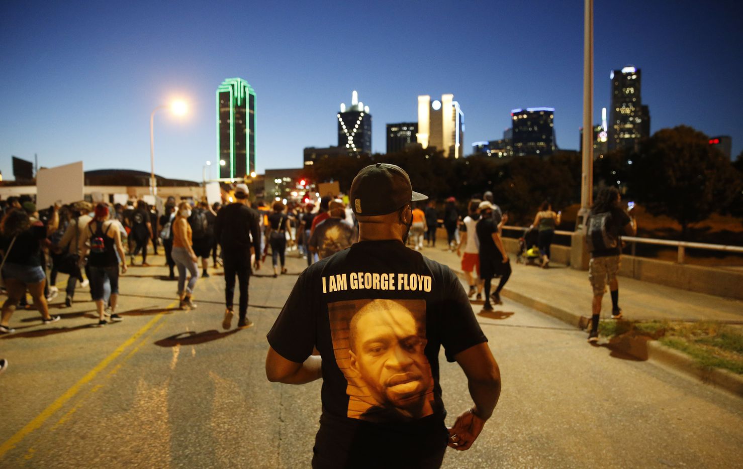 Protesters march during a demonstration against police brutality in downtown Dallas, on...