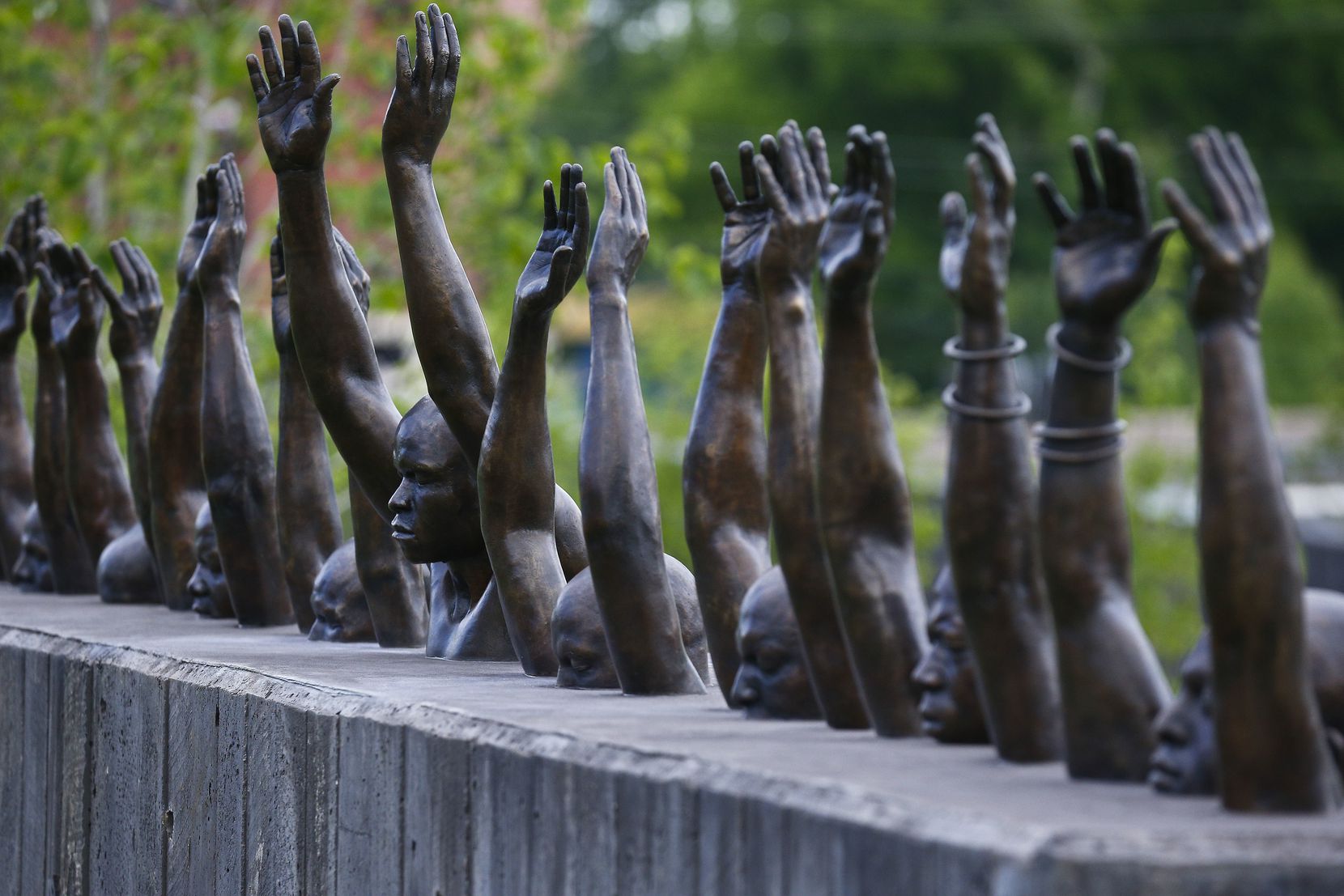 The bronze sculpture Raise Up by Hank Willis Thomas addresses police violence against...