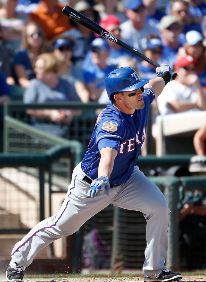 SURPRISE, AZ - MARCH 02:  Justin Ruggiano #25 of the Texas Rangers hits a single against the...