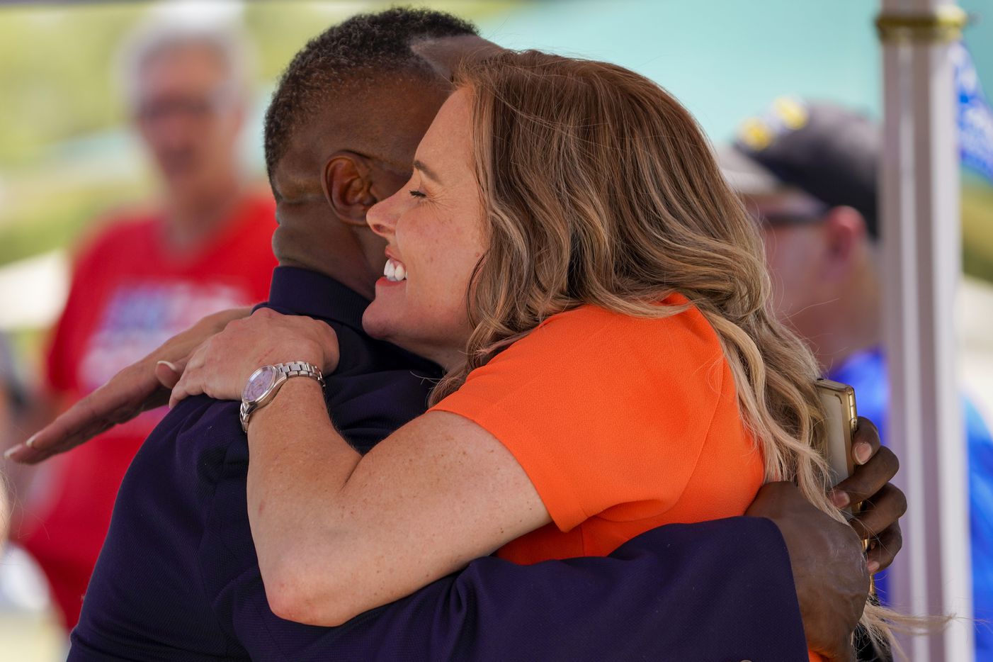 Shelley Luther, owner of Salon  la Mode,  hugs Keenan Williams, Strategic Initiatives Director for the Trump 2020, during a campaign rally and boat parade in support of President Donald Trump at Oak Grove Park on Grapevine Lake on Saturday, Aug. 15, 2020.
