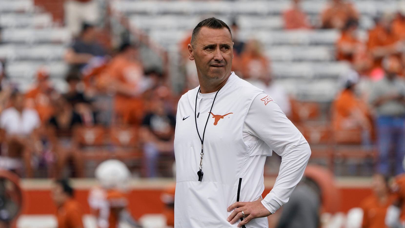 Texas head coach Steve Sarkisian watches warm up before an NCAA college football game...