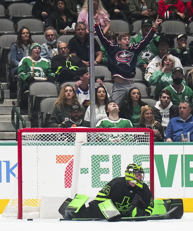 A Columbus Blue Jackets fan cheers after Dallas Stars goaltender Jake Oettinger (29) allowed a goal during the first period of an NHL hockey game at the American Airlines Center on Thursday, Dec. 2, 2021, in Dallas.