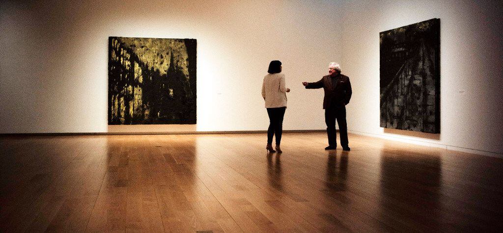 Artist Donald Sultan, right, talks to an exhibit attendee at the Modern Art Museum of  Fort...