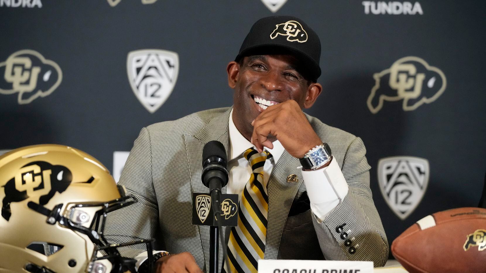 Deion Sanders speaks after being introduced as the new head football coach at the University...