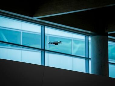 Investigators use a drone inside the ticketing hall at Dallas Love Field Airport on Monday,...