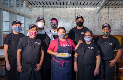 Anastacia Quiñones-Pittman, head chef of the Dallas restaurant José, poses with her staff...