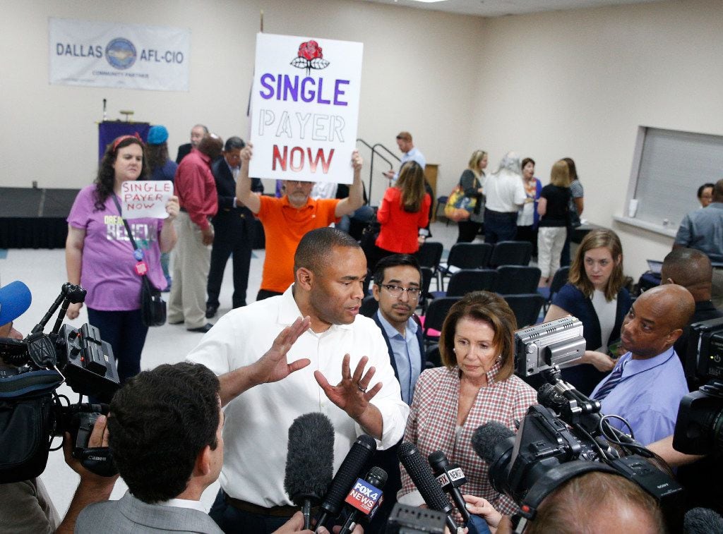 U.S. Representatives Marc Veasey (left) and Nancy Pelosi talk to the media after a rally at...