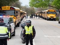 Lamar High School students and faculty are evacuated by Arlington Police Officers after a...