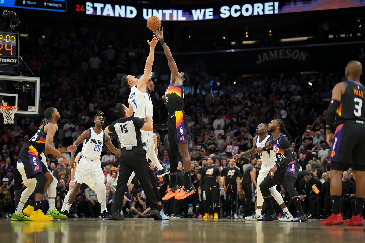 Phoenix Suns center Deandre Ayton (22) wins the opening tipoff from Dallas Mavericks center...