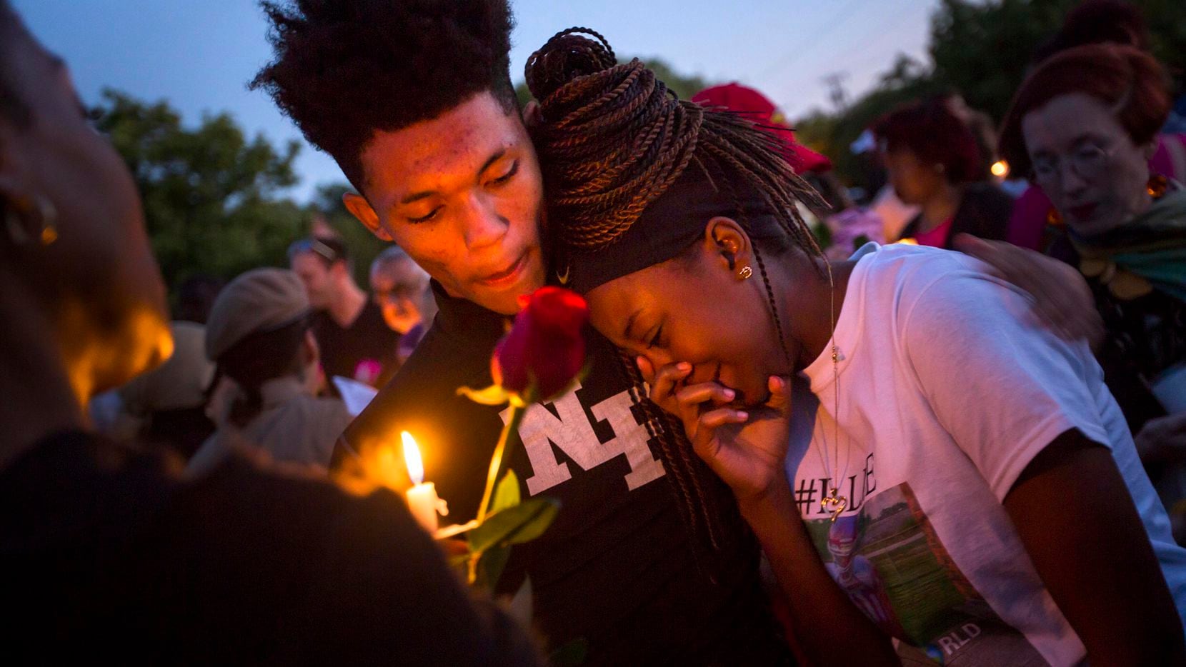 Ashuntae Coleman, 14, is consoled by De'Juan Johnson, 15, during the "Remember His Name:...