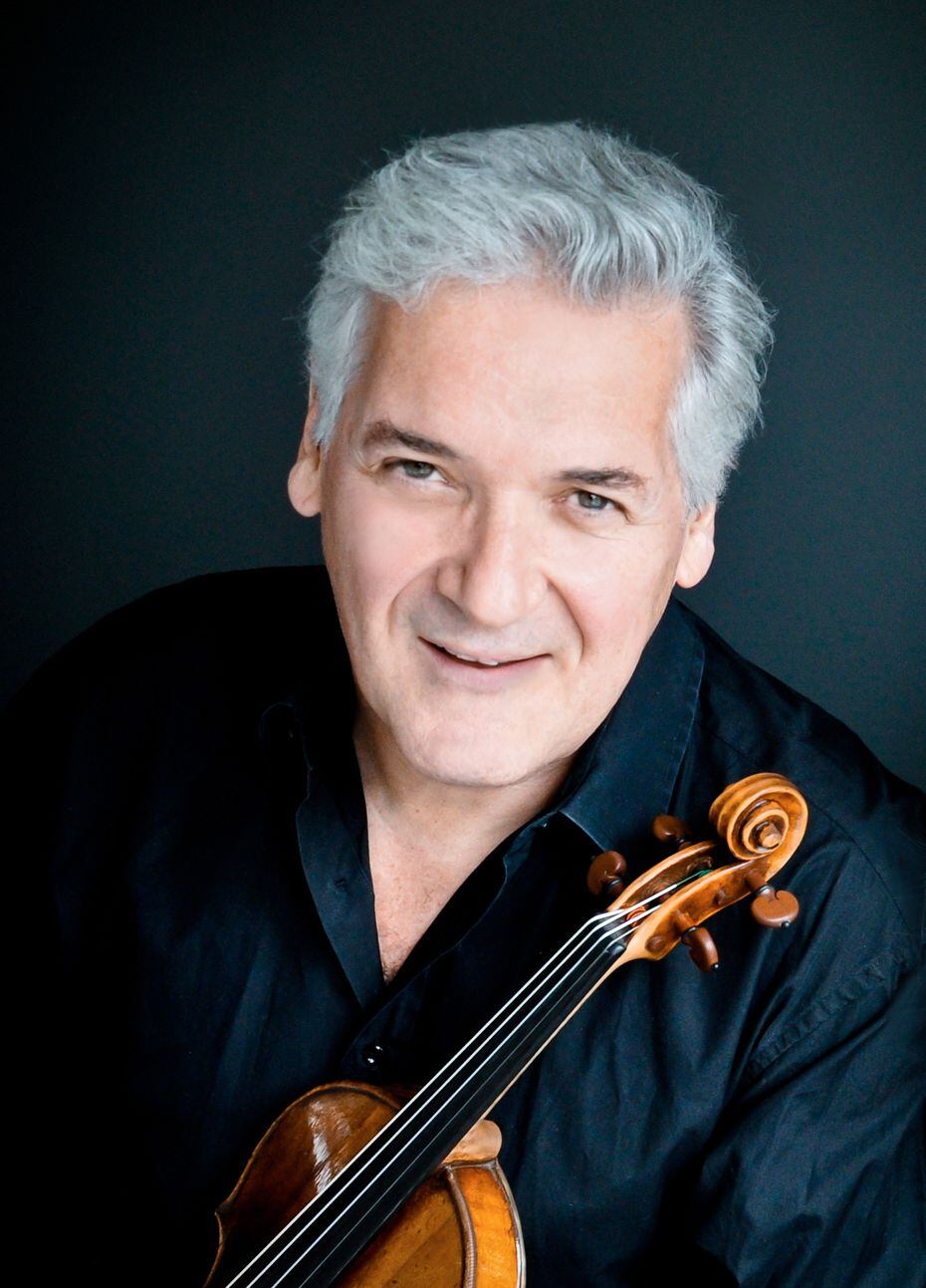 A headshot of Pinchas Zukerman holding a violin.