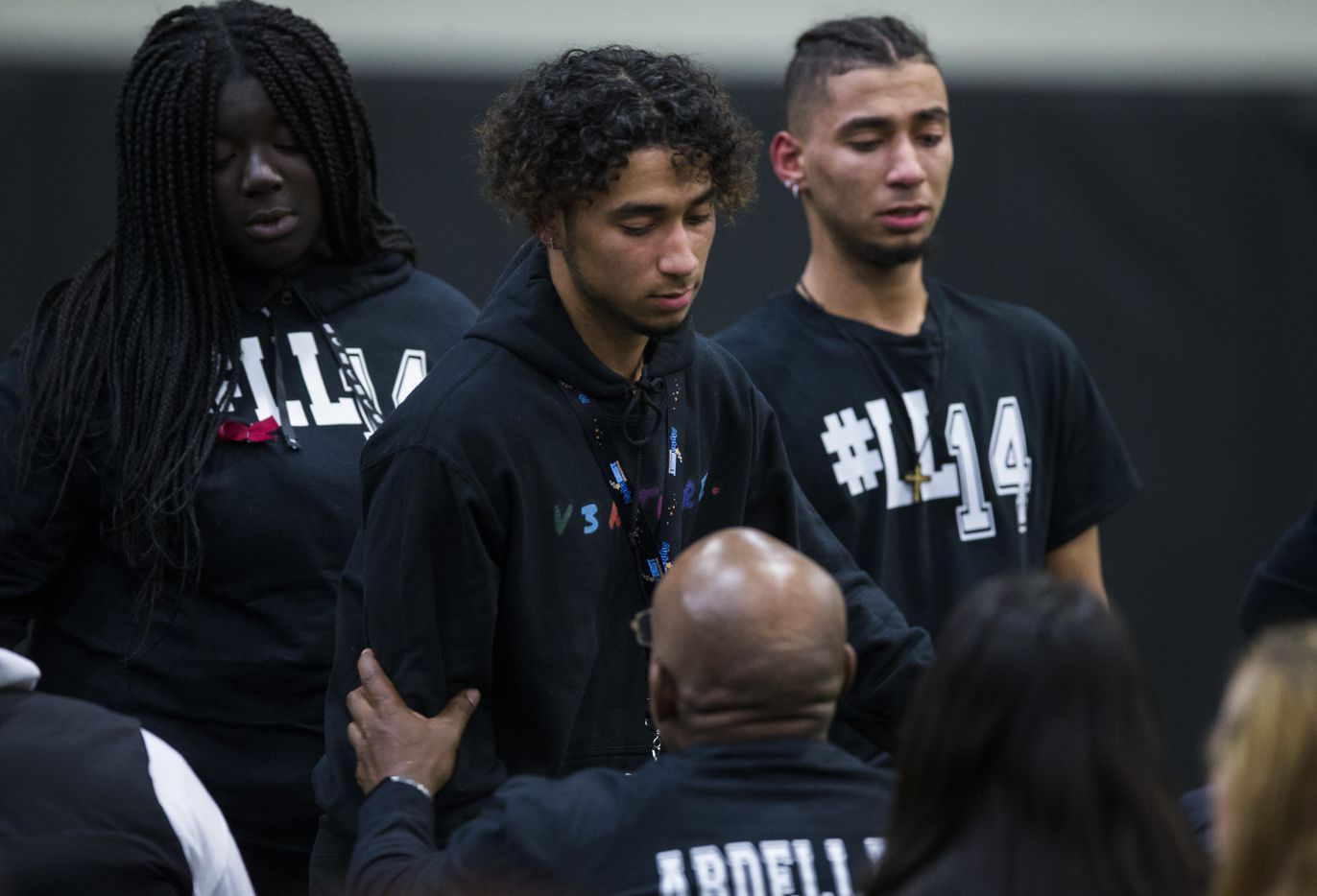 Student athletes embrace and cry with Amandla Abdellatif (center, bottom), father Wylie High...