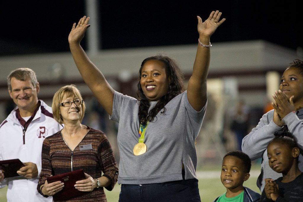 Michelle Denee Carter (center), Rio Olympics gold medalist shot putter waves to the crowd...