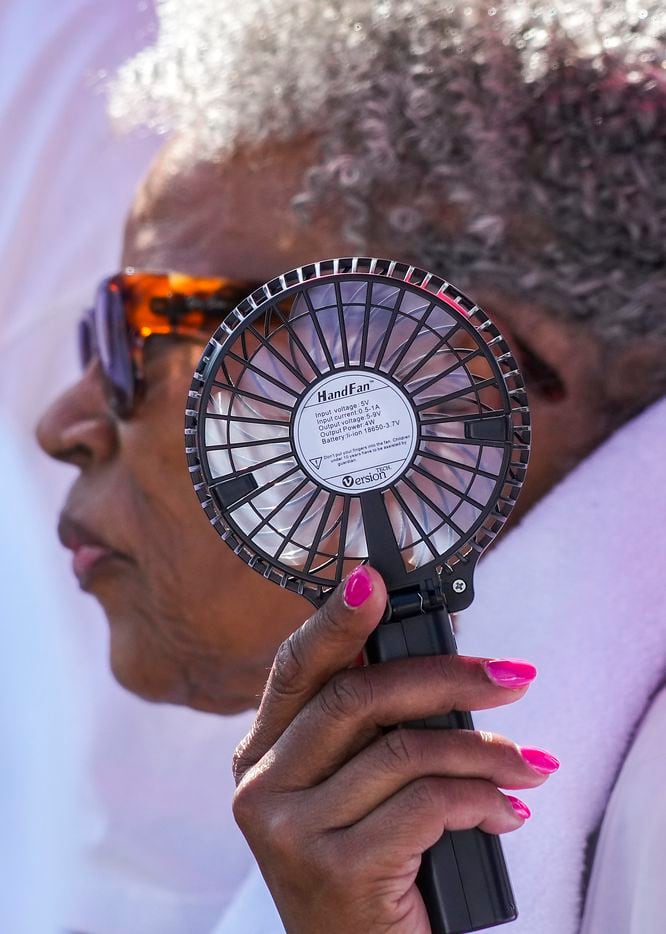 A family member hold a portable fan for Opal Lee during the 2022 Opal's Walk for Freedom on...