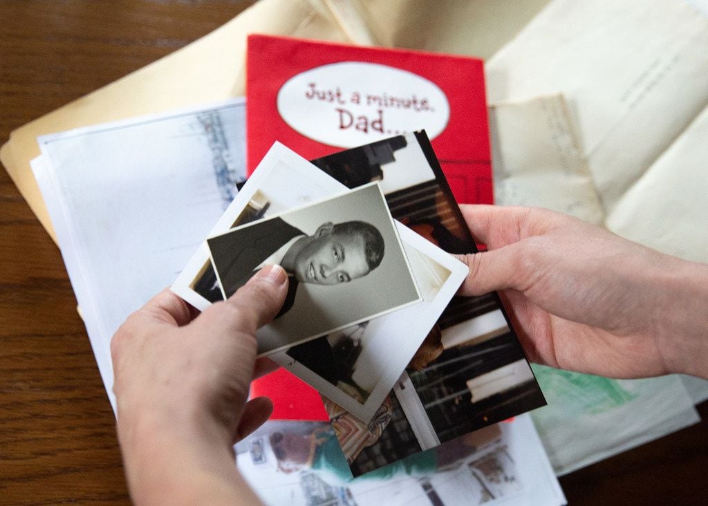 Janielle Kastner looks through old photos and cards belonging to her late father. 