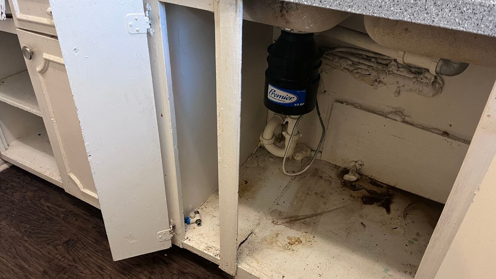 Water leaks created mold under a kitchen sink in a rental apartment in the Bachman Lake...