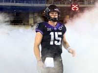 FILE - TCU quarterback Max Duggan (15) stands at a tunnel exit during team introductions...