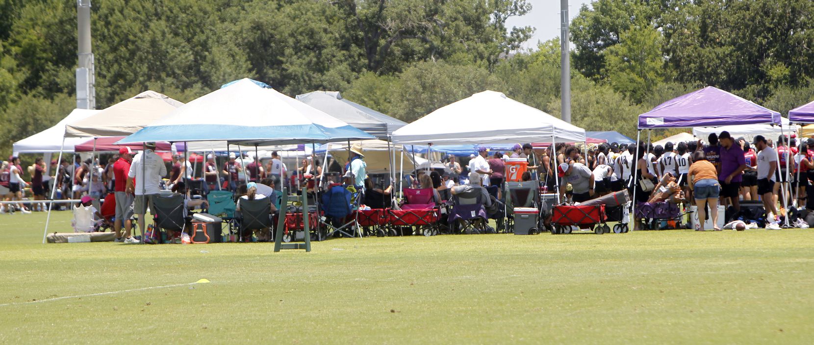 Pop up canopies were found in numbers as teams and fans sought out relief from the sun....