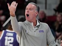 TCU head coach Jamie Dixon gestures toward his players during the second half of an NCAA...