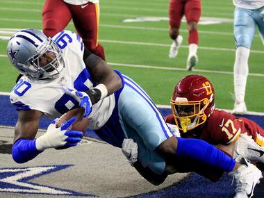 Dallas Cowboys defensive end Demarcus Lawrence (90) falls into the end zone for a touchdown,...