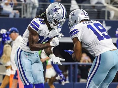 Dallas Cowboys' CeeDee Lamb (88) and Amari Cooper (19) celebrate a touchdown during the...