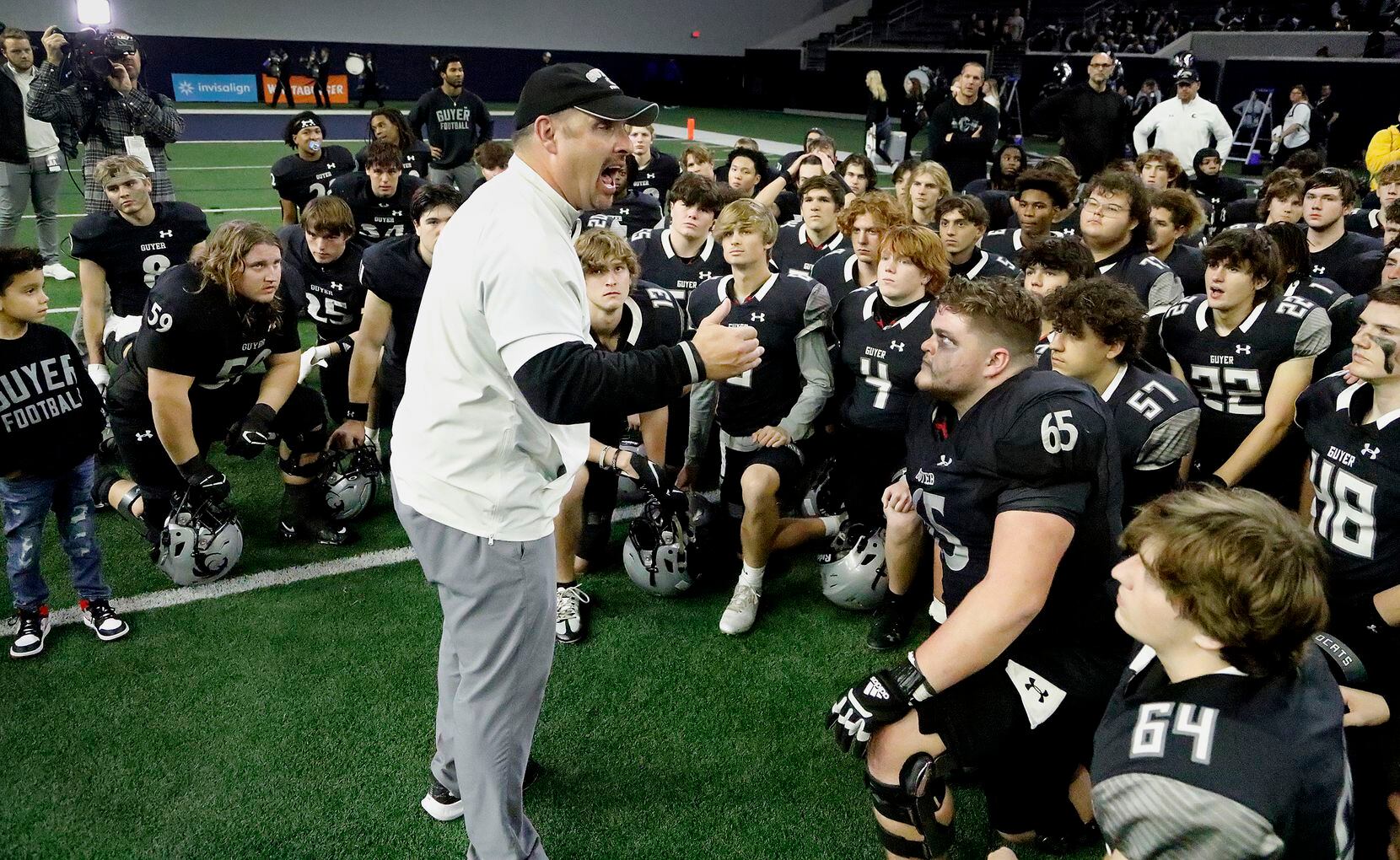 Guyer High School head coach Reed Heim gives a talk to his team after the victory as Byron...