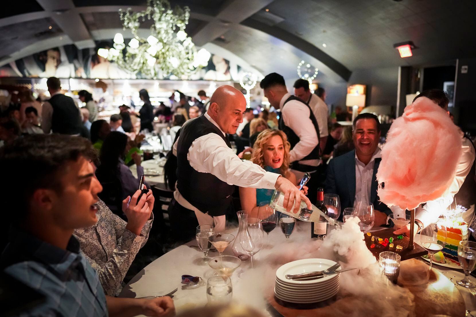Benny Bajrami pours dry ice cocktails for guests Jenee and Nick Stefanakis during a birthday...