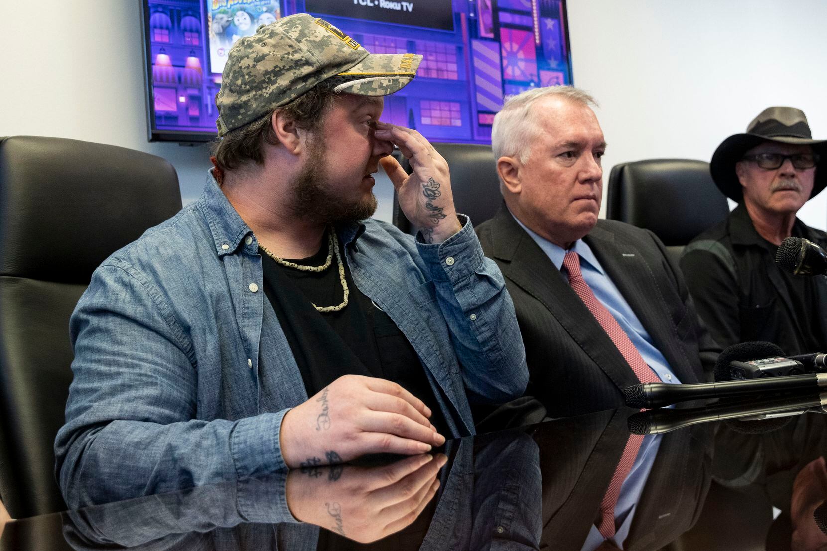 Kyle Vess (left), the homeless man who was kicked by Dallas Fire-Rescue paramedic Brad Cox in 2019, described the injuries to his face as his attorney George Milner III (center) and father Kevin Vess listened on Wednesday, Oct. 27, 2021, in Dallas. (Juan Figueroa/The Dallas Morning News)