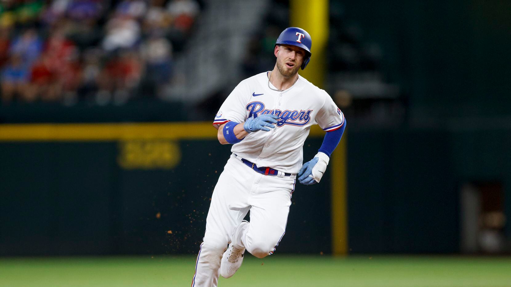 Texas Rangers designated hitter Mitch Garver (18) rounds second base after a double by right...