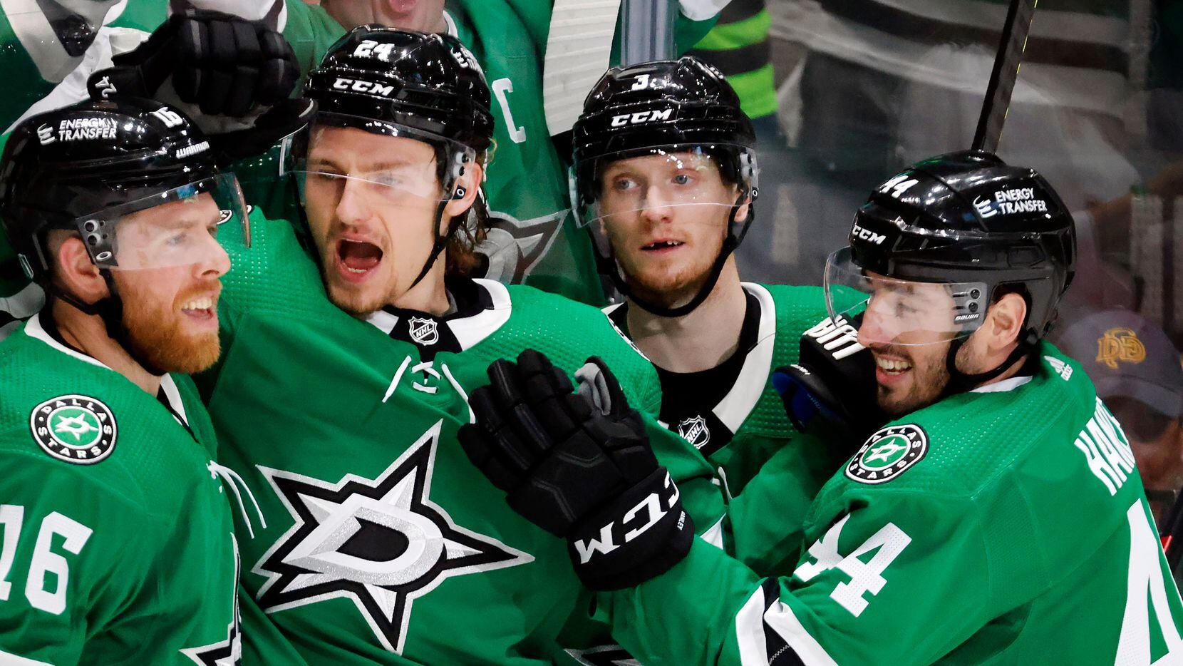 Dallas Stars center Roope Hintz (24) is congratulated on his first period goal by teammates...