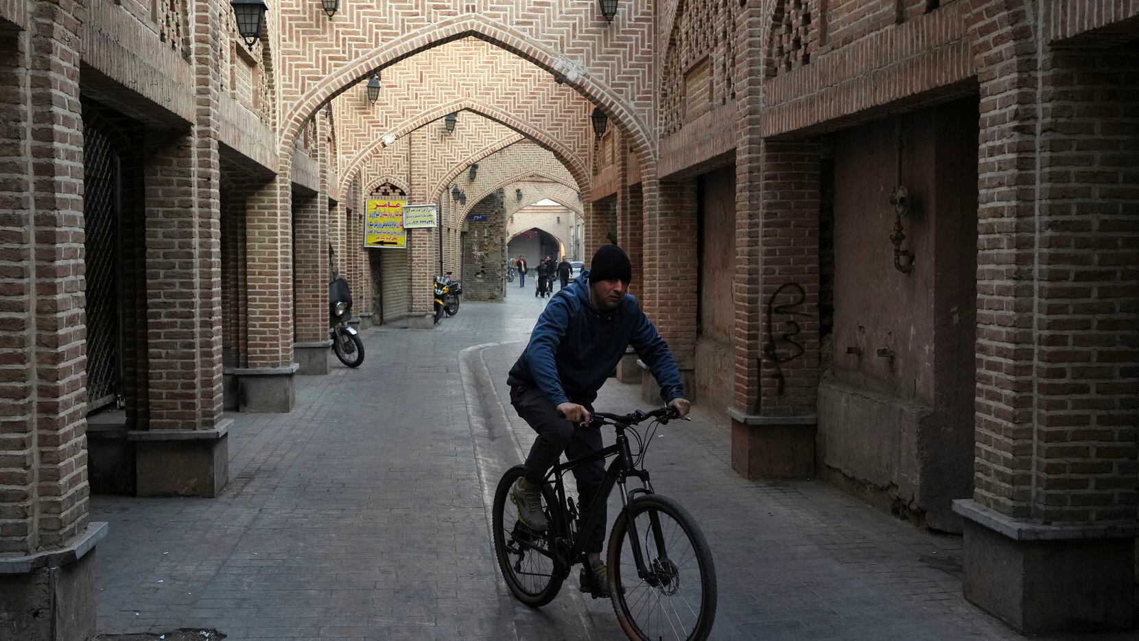 A man rides a bicycle in an old neighborhood of Tehran, Iran, Tuesday, Jan. 24, 2023. Since...