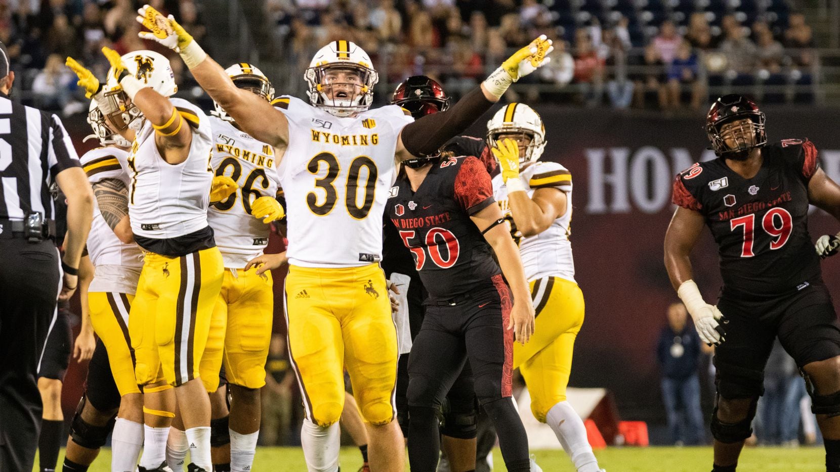 File - Wyoming linebacker Logan Wilson (30) celebrates a missed field goal by San Diego...