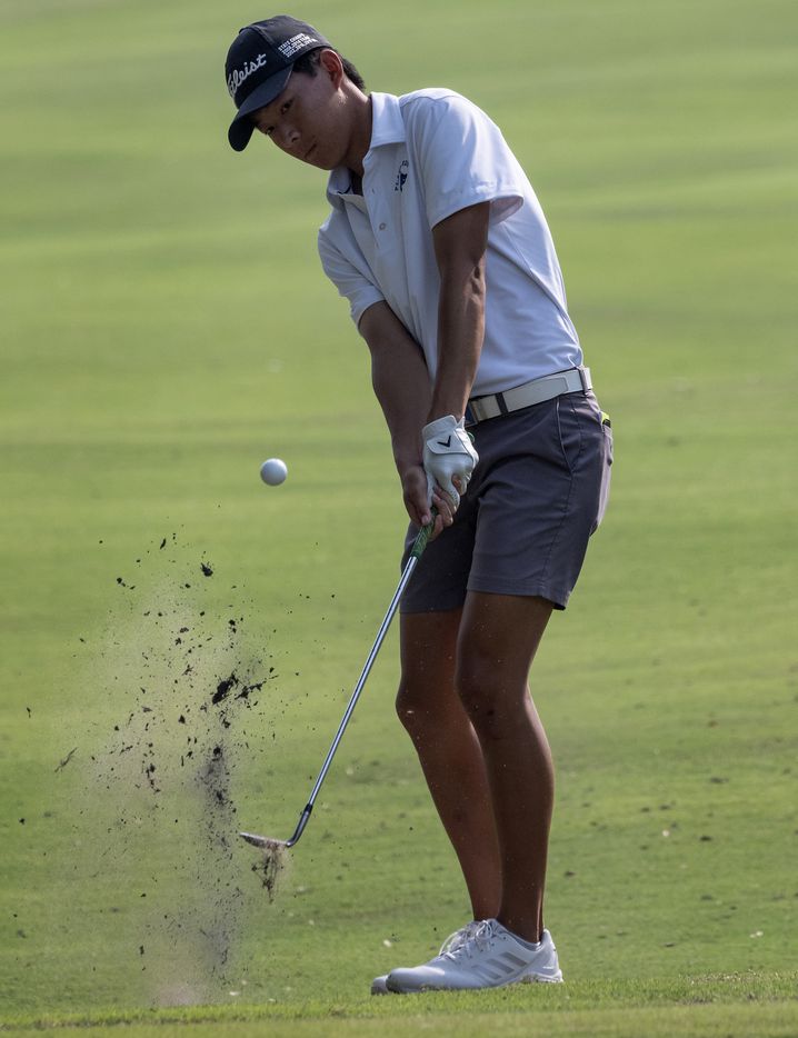 Plano West, Ethan Fang, chips up on the no.1 green during the first round of the UIL Class...
