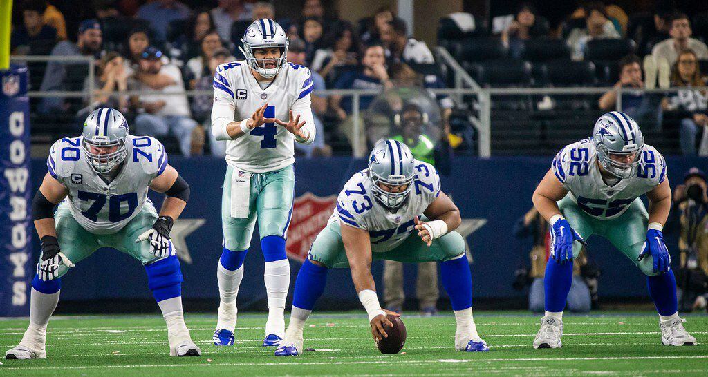 Dallas Cowboys quarterback Dak Prescott (4) lines up behind offensive guard Zack Martin...