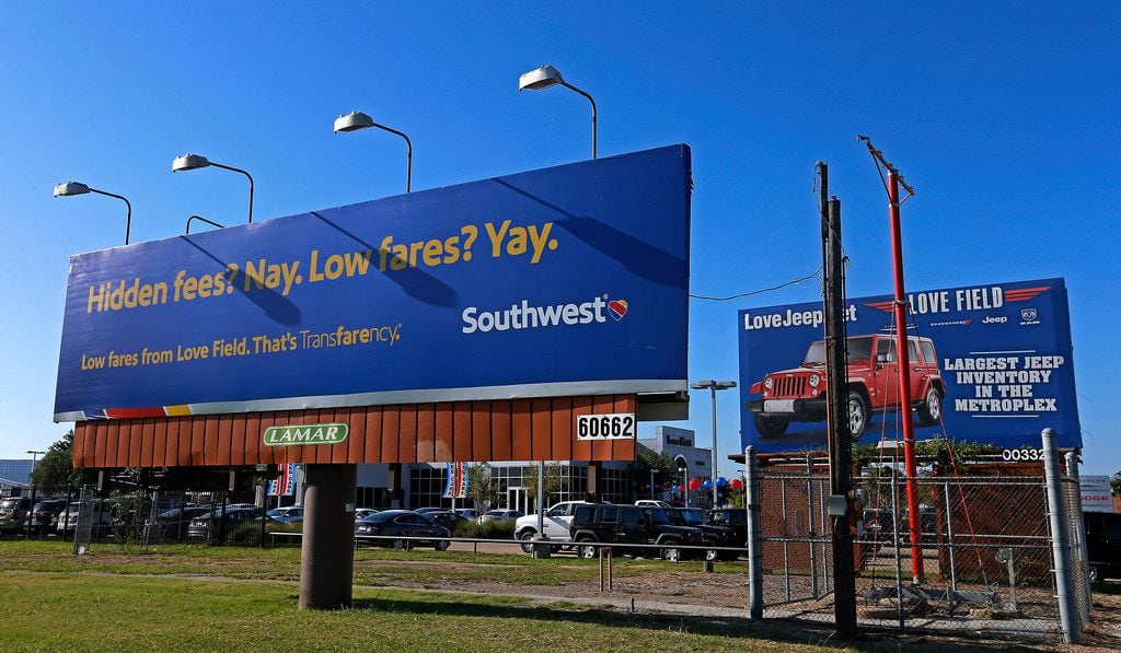 Billboards for Southwest Airlines and Love Field Chrysler Dodge Jeep Ram dealership are seen...