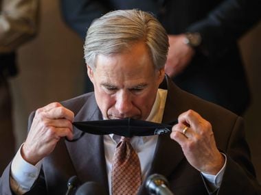 Gov. Greg Abbott takes off his face mask to start a press conference in Dallas, March 17, 2021, to address the arrival of a few hundred immigrant teen boys from the border to the Kay Bailey Hutchison Convention Center. The convention center will serve as an emergency intake site to hold teens who have arrived at the U.S.-Mexico border starting Wednesday to decrease overcrowding at Customs and Border Protection facilities.