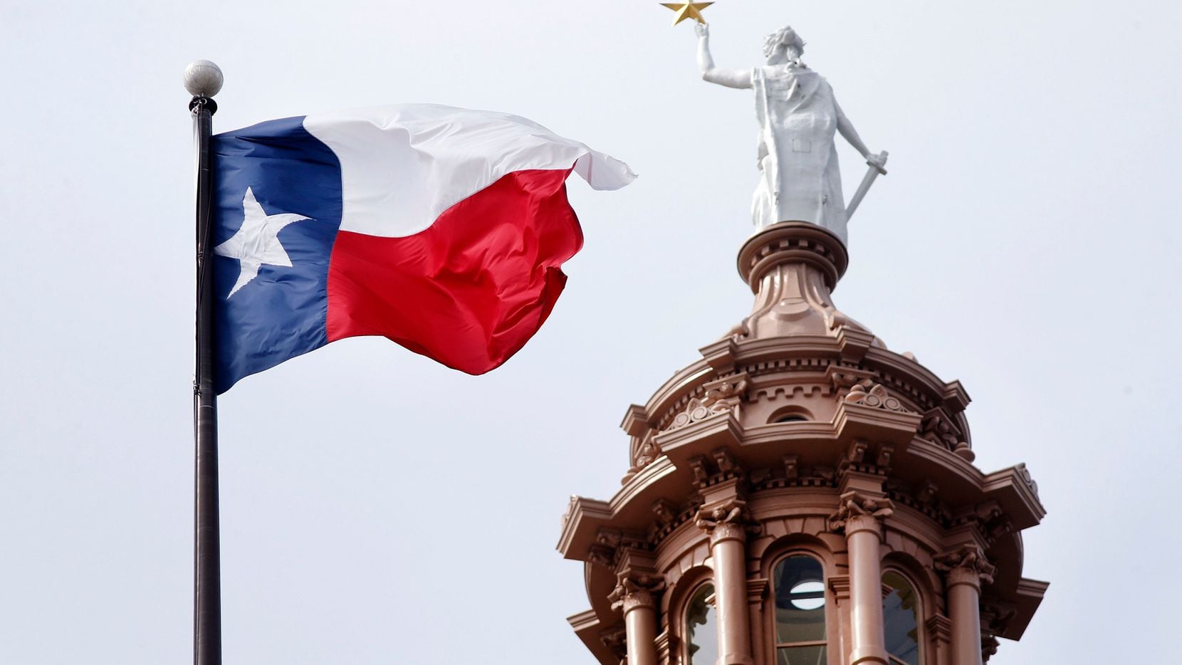 The Texas flag flies over the Texas Capitol in Austin, Texas, Wednesday, May 22, 2019.