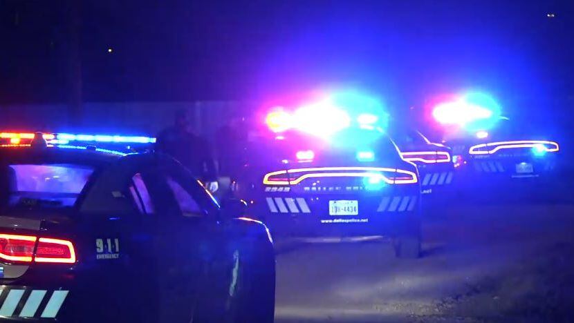 Several Dallas police squad cars line a street near when a 40-minute chase came to an end...
