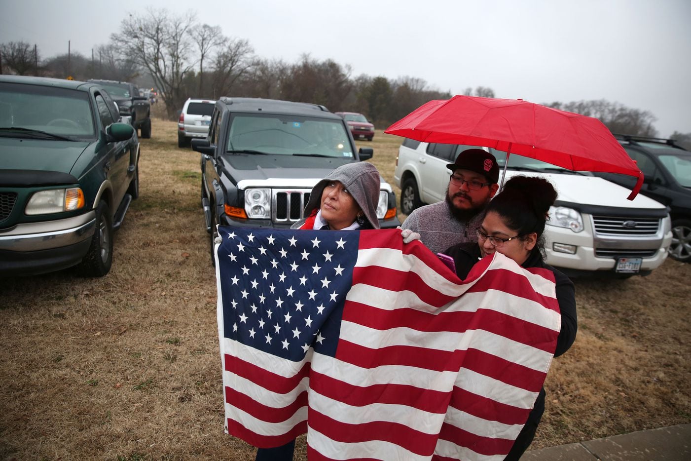 Sandra Perez (far left) waits with her daughter Jessica Avila and son-in-law Joel Avila before the funeral procession for Richardson police officer David Sherrard outside Sacred Heart Cemetery in Rowlett, Texas on Tuesday, Feb. 13, 2018. 