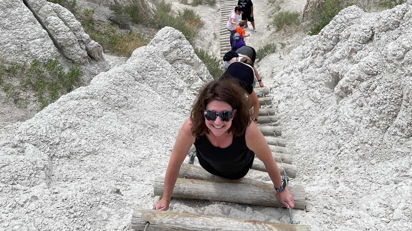 Tyra climbs down a 50-foot ladder along the Notch Trail in Badlands National Park.