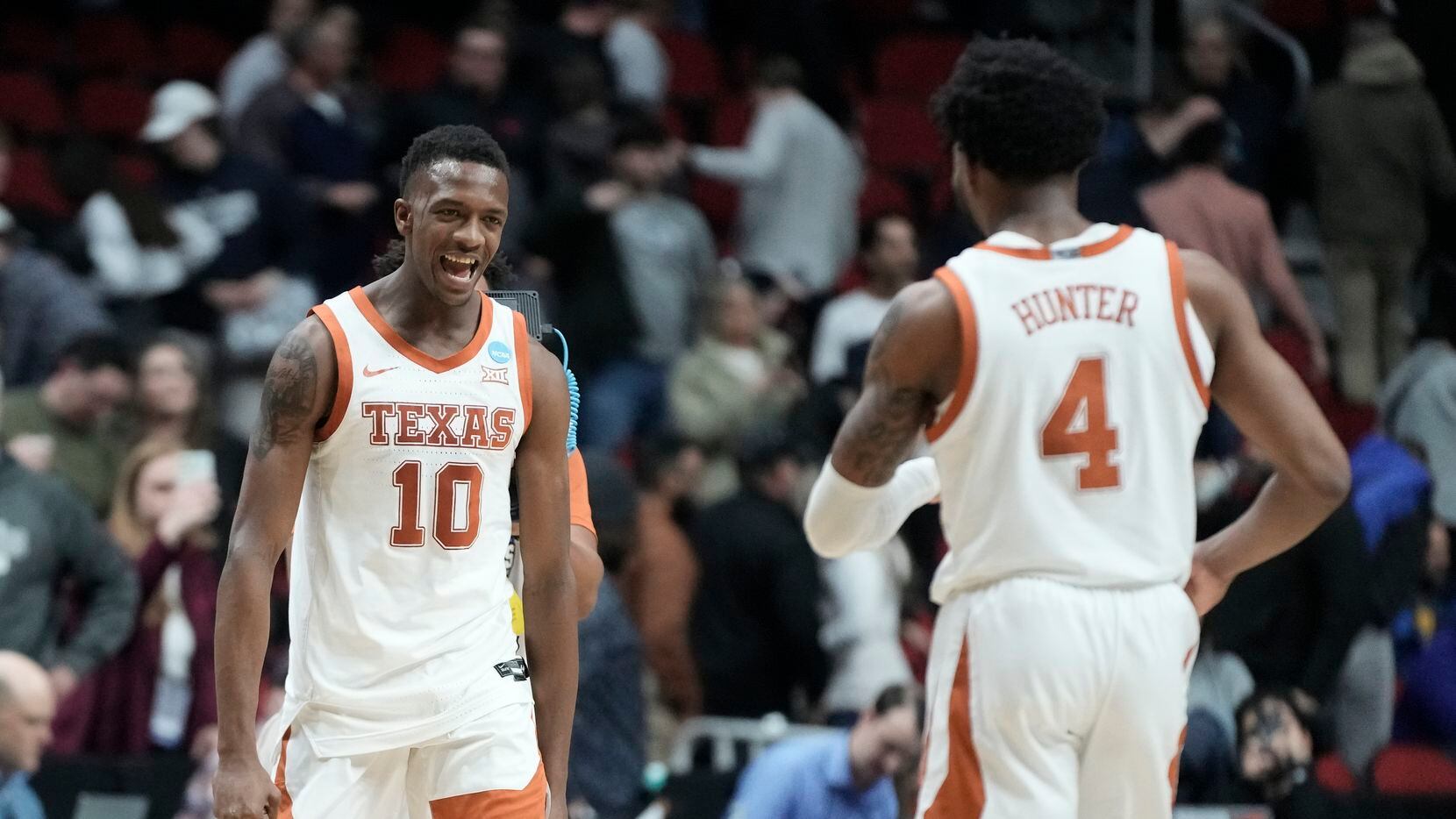 Texas' Sir'Jabari Rice and Tyrese Hunter celebrate after a second-round college basketball...