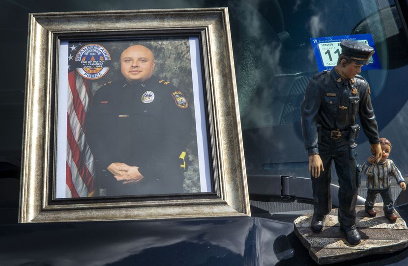 A photograph of Grand Prairie Police Officer Albert "A.J." Castaneda and a statue adorn the...