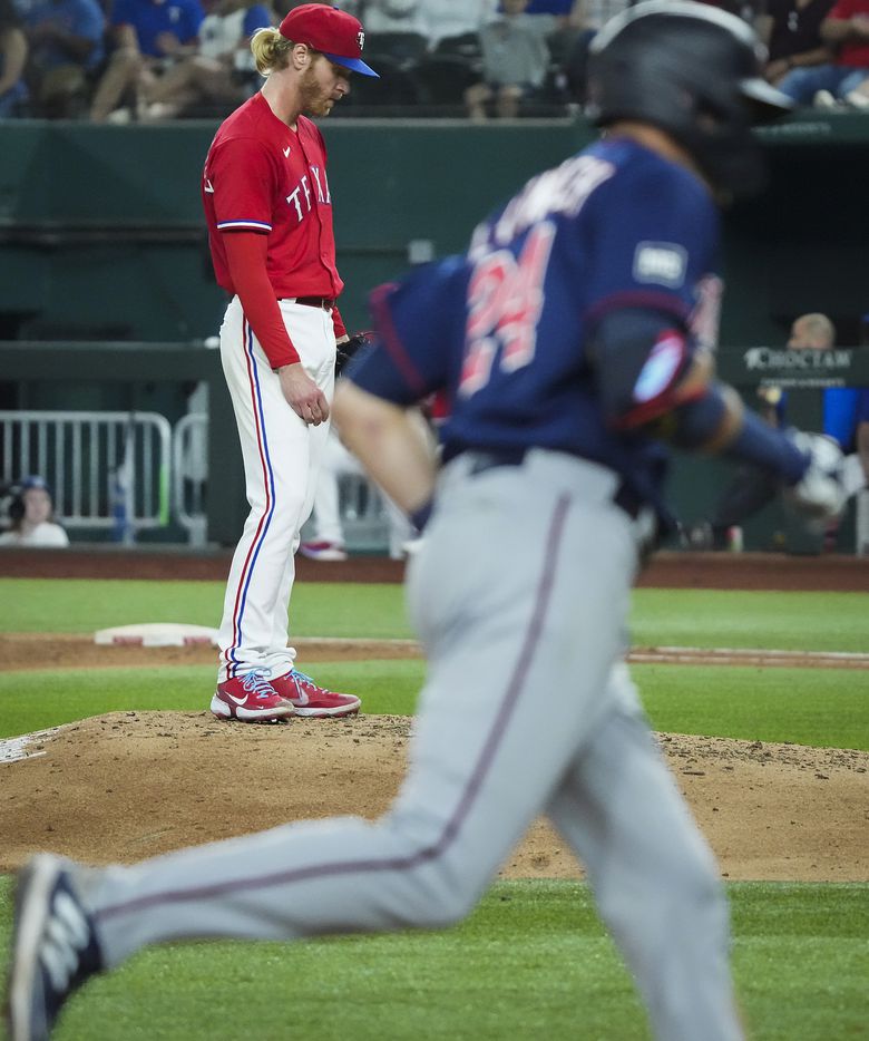 Texas Rangers starting pitcher Mike Foltynewicz looks down as Minnesota Twins left fielder...