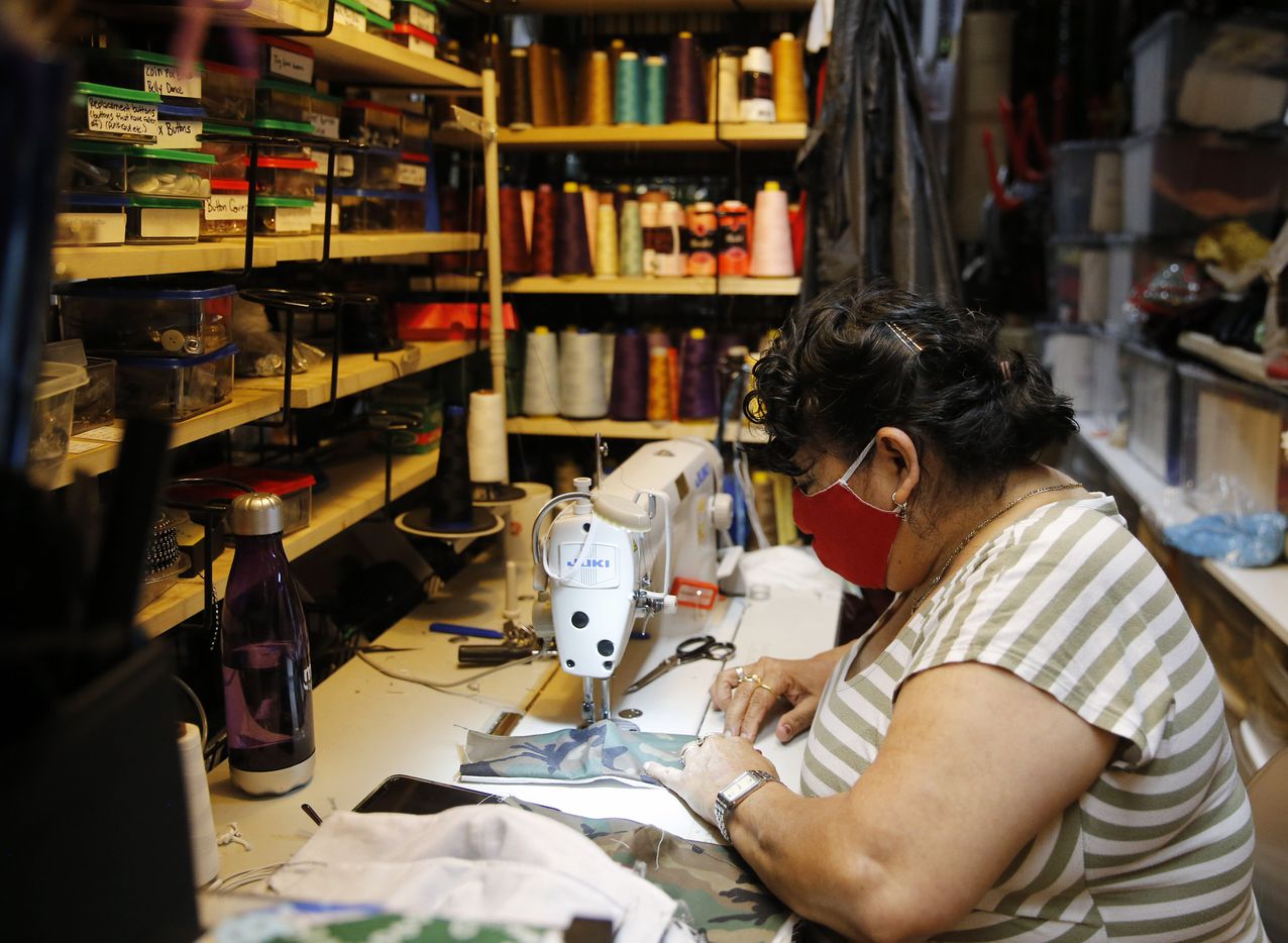 Maria Escobar works on putting cloth masks together at Dallas Vintage Shop in Plano, Texas...