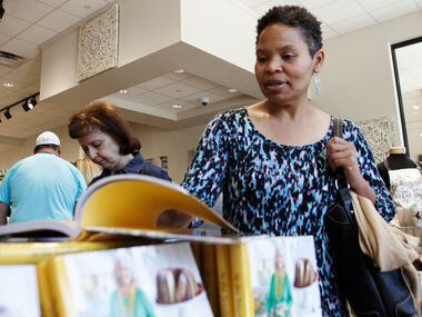 Kristal Ford of Plano looking at a Paula Deen book in the retail shop inside Paula Deen's...